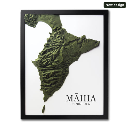 Framed wall art featuring a 3D relief map of the Máhia Peninsula in olive green tones on a white background, with the text 'MÁHIA PENINSULA' at the bottom and a small 'New design' badge in the top right corner.